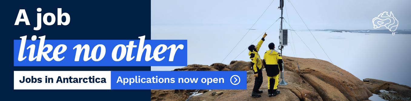 Image: Two people stand on a rocky area working on a wire tower. Text reads 'A job like no other. Jobs in Antarctica. Applications now open.'