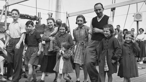 Ablack and white photo of a large family walking together