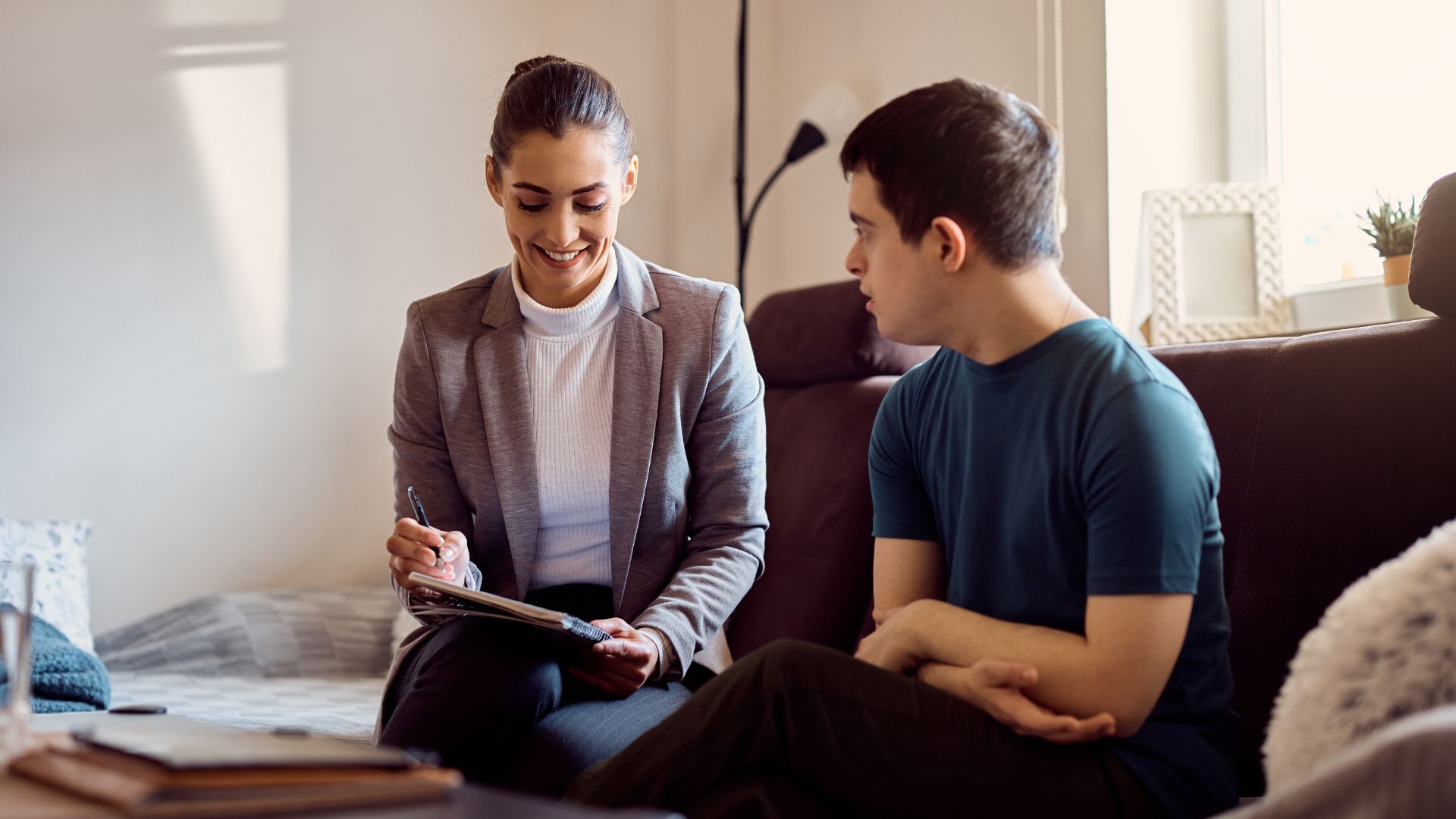 This is a photo of a teenager with Down syndrome speaking with a female psychologist