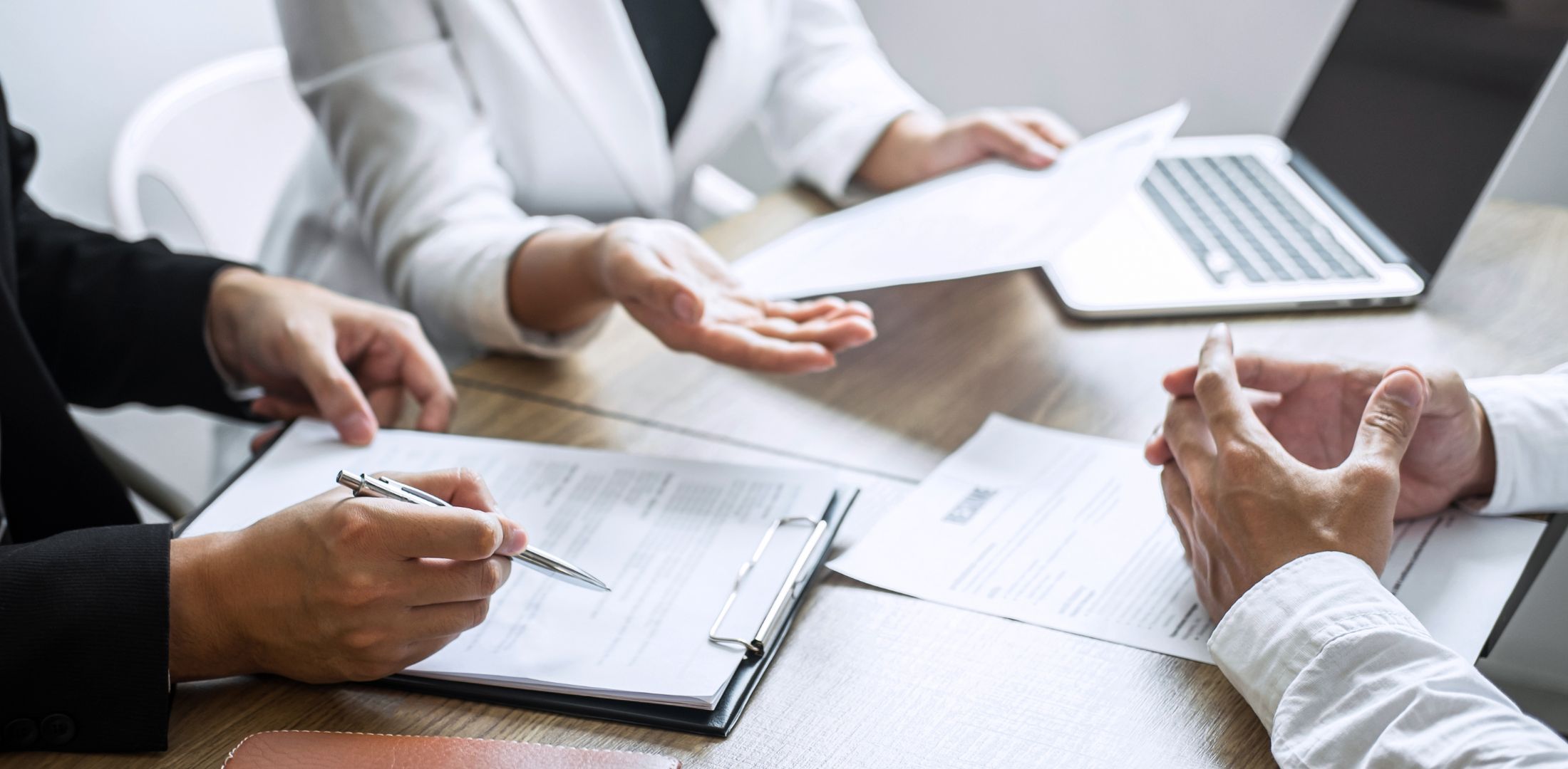 This is a photo of three people in a meeting setting