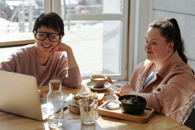 Two women look at a computer