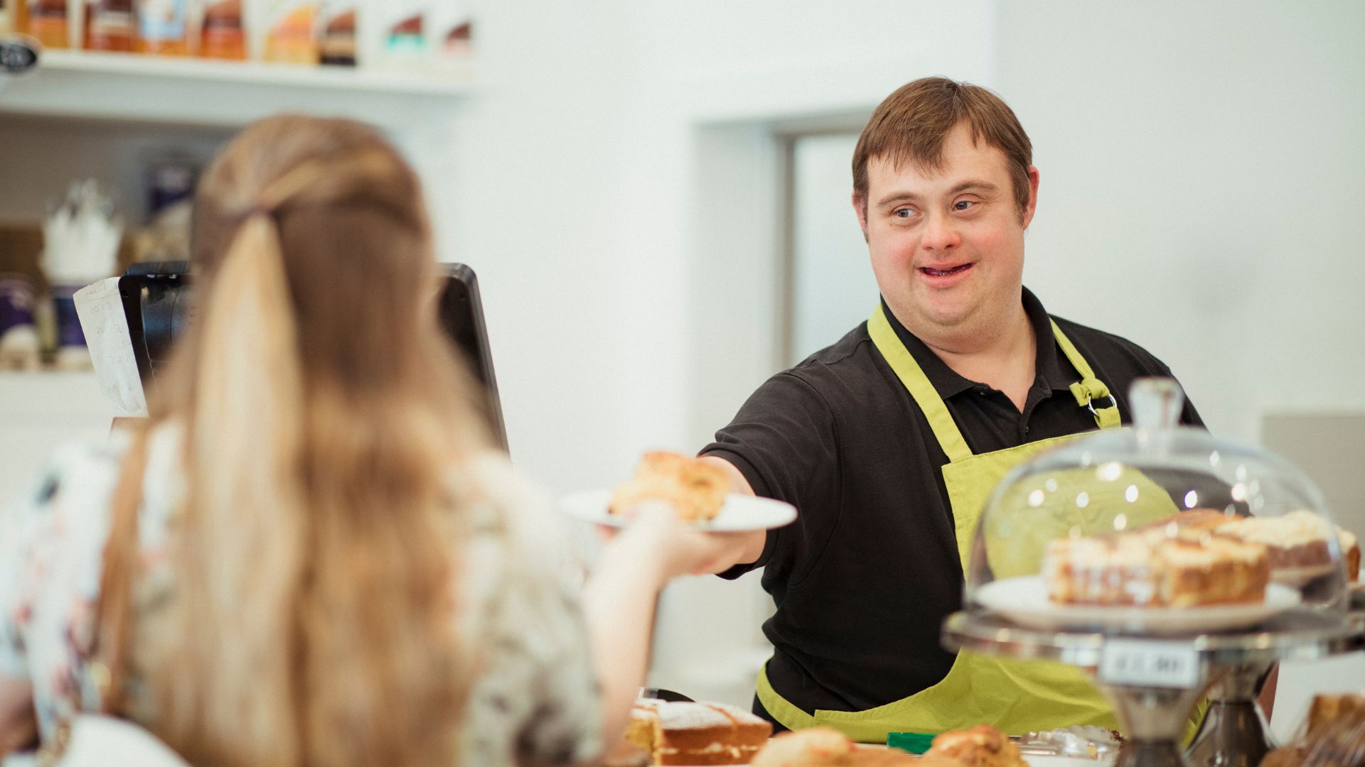 This is a photo of a man with Down syndrome working at a cafe