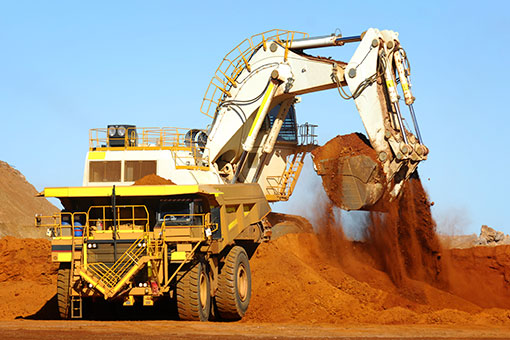 Excavator loading ore into a haul truck