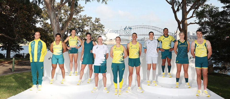 Members of the Australian Olympic team showcasing their uniform with a backdrop of the Sydney Opera House and Harbour Bridge