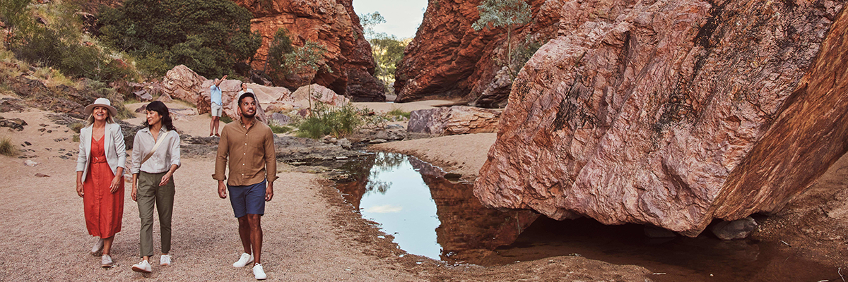 Tourists walking through the West MacDonnell Ranges, Alice Springs