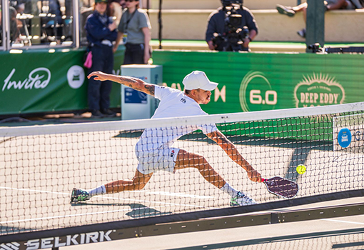 Male pickleball player playing on court