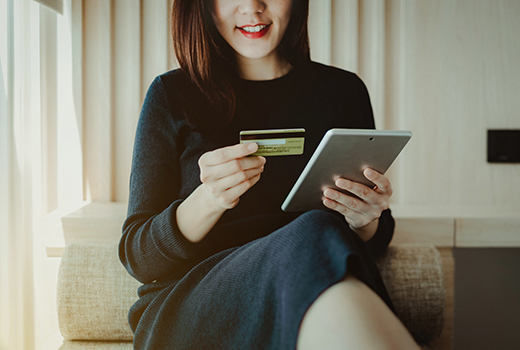Young Asian woman shopping online with credit card and digital tablet