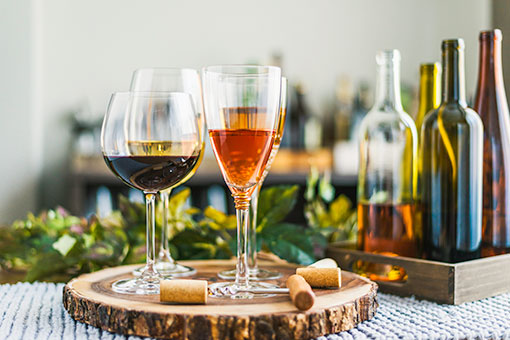 Glasses of red, rose and white wines on a wooden platter