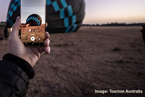 Person taking a photo of a hot air balloon