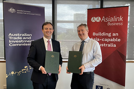 Representatives of Austrade and Asialink holding signed agreement