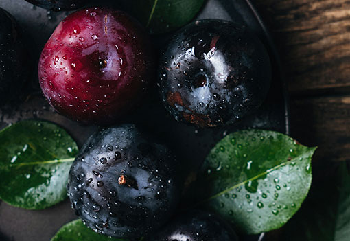 Cluster of plums on a wooden table